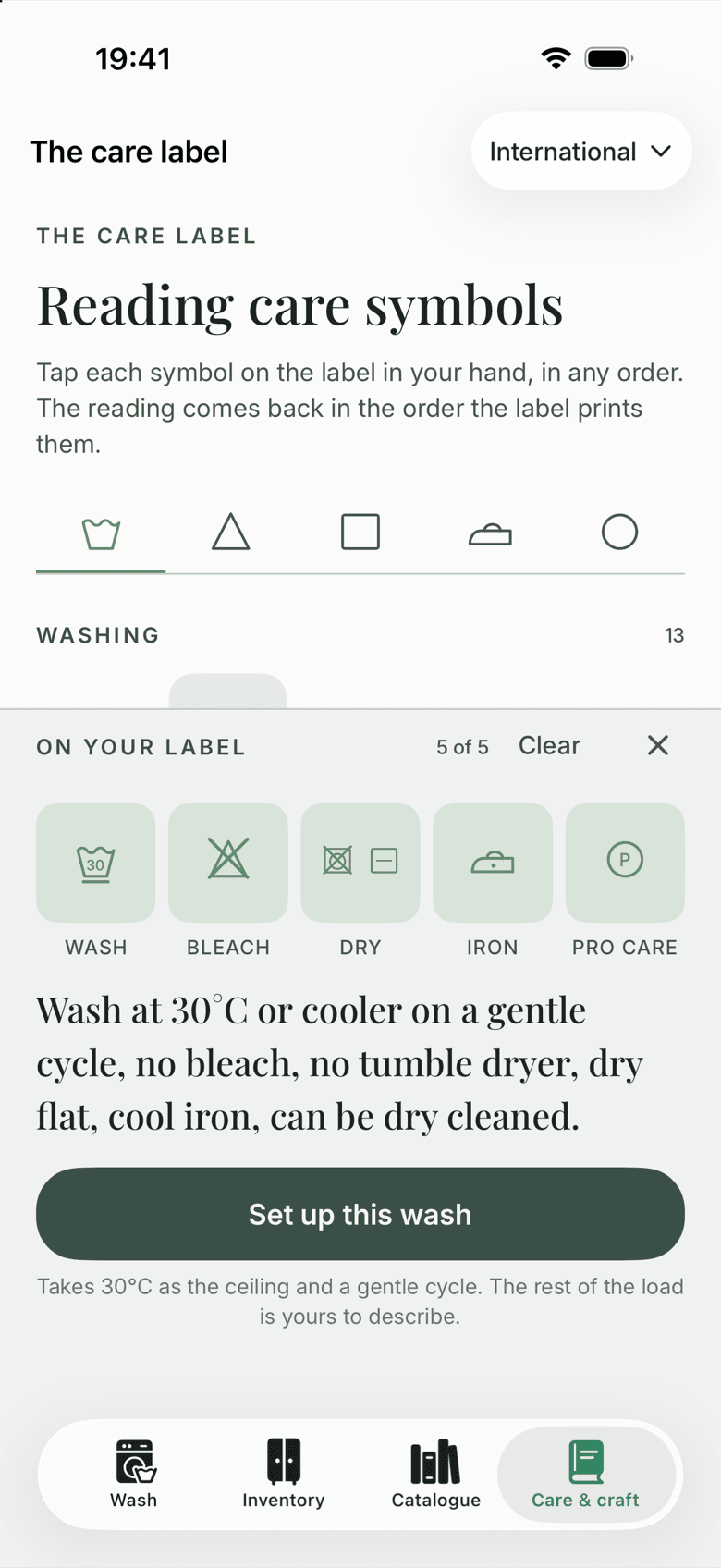 Read my label: six symbols tapped and set in their five places on the label (wash, bleach, dry, iron, professional care), read back as ‘Wash at 30°C or cooler on a gentle cycle, no bleach, no tumble dryer, dry flat, cool iron, can be dry cleaned’, above a ‘Set up this wash’ button