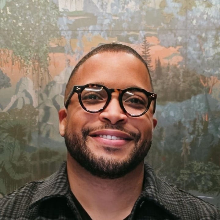 Nick Townsend, smiling, in round tortoiseshell glasses
